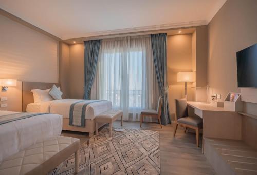a hotel room with a bed and a desk at Haile Grand Addis Ababa in Addis Ababa