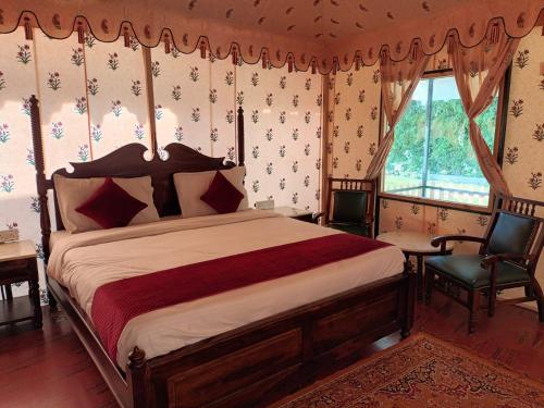 a bedroom with a large bed in a room at Hotel Green Haveli - A Heritage and Hill View Hotel , Pushkar in Pushkar