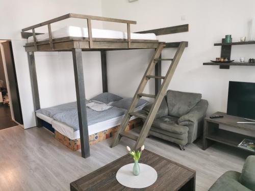 a living room with a bunk bed and a couch at Centrum Apartman Kukucinova6 in Košice