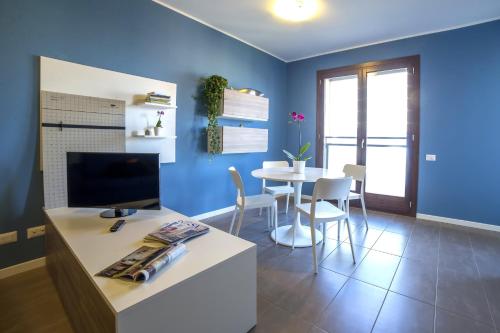 a living room with a table and a blue wall at Residence Milano Bicocca in Milan