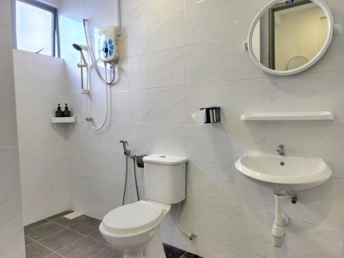 a white bathroom with a toilet and a sink at PROMO - Ipoh Casa Kayangan Meru, Pool View, Near Bus Station, Toll & Tambun, Free Wi-Fi, Free 3 Parking in Ipoh