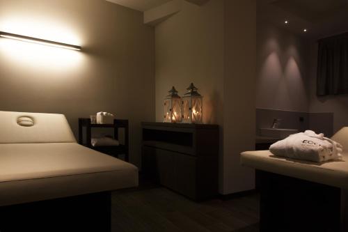 a bedroom with a bed and a sink and a light at Ego Hotel in Ancona