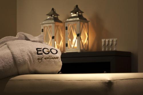 a towel with the word ego and a fireplace at Ego Hotel in Ancona