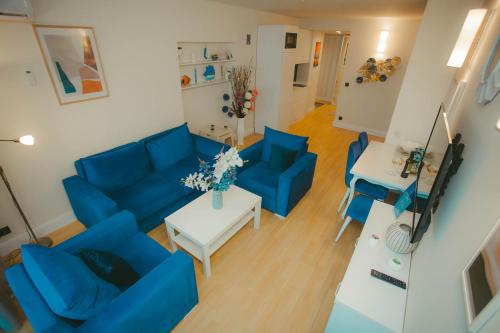 an overhead view of a living room with blue couches and a table at Come a Lot Aparthotel Batumi in Batumi