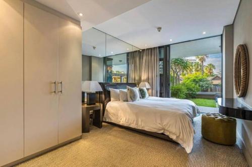 a bedroom with a large bed and a large window at Luxury Villa in V&A Waterfront in Cape Town