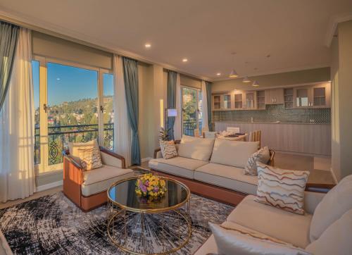 a living room with couches and a glass table at Haile Grand Addis Ababa in Addis Ababa