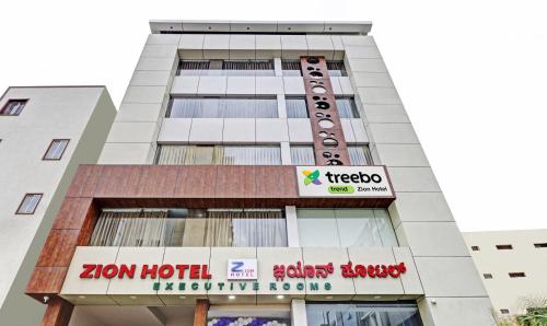 a building with a sign for a hotel at Treebo Trend Zion in Bangalore