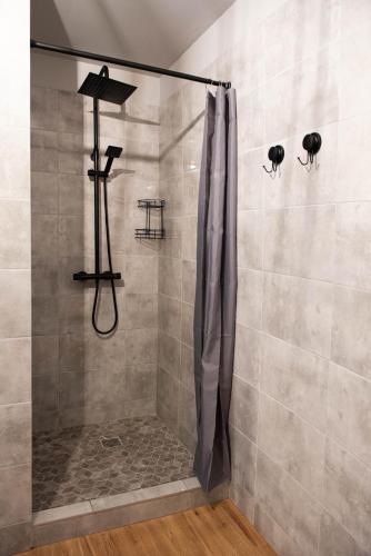 a shower in a bathroom with a shower curtain at Przystań in Stalowa Wola