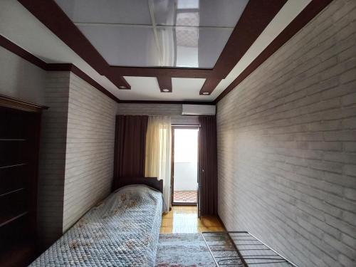 a bedroom with a bed and a ceiling at Apartment Center 1 in Tashkent