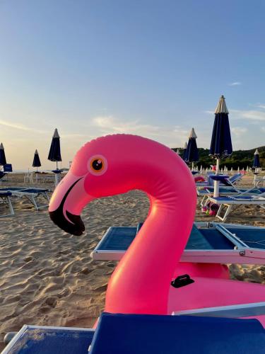 a pink flamingo float on the beach at Hotel Portonuovo in Vieste