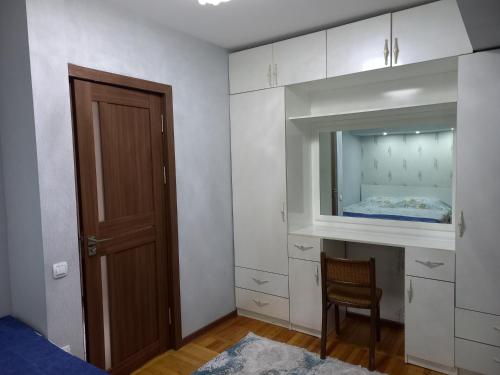a bedroom with a bed and a mirror and a door at Apartment Center 1 in Tashkent