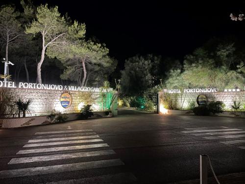 a gate to a road at night with lights at Hotel Portonuovo in Vieste