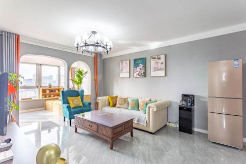 a living room with a couch and a table at Cloud & Sea Boutique Apartment in Rizhao