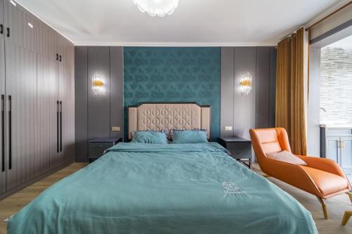 a bedroom with a large bed and a chair at Cloud & Sea Boutique Apartment in Rizhao
