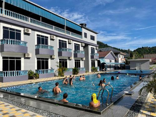 a group of people in the swimming pool at a hotel at SURIA BEACH RESORT Pangkor in Pangkor