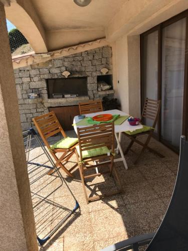 a patio with a table and chairs and a tv at Studio de 39 m2 in Vezzani