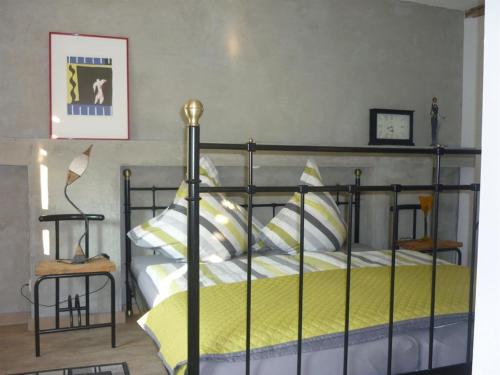 a bedroom with a bed with yellow and white pillows at Ferienhaus Laux in Weiskirchen