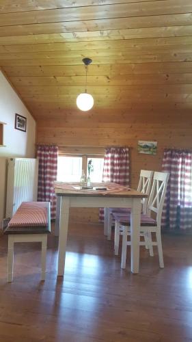 a dining room with a table and two chairs at Hof Rossruck in Fischbachau