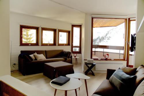 a living room with two couches and a table at Munk - Avoriaz in Avoriaz