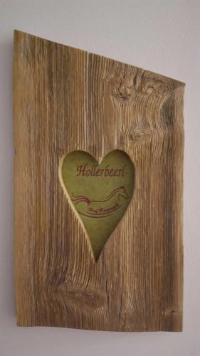 a wooden heart with the word heartbeat on it at Hof Rossruck in Fischbachau