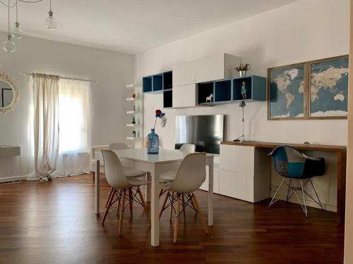 una cucina e una sala da pranzo con tavolo e sedie di La Rocca Luxury Apartment a Parma