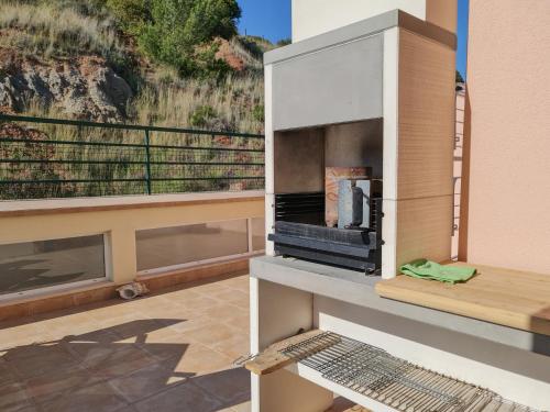 a living room with a fireplace on a balcony at Luxe villa Sesimbra secret corner 2 in Sesimbra