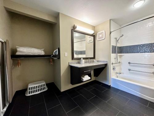 a bathroom with a sink and a tub and a mirror at Staybridge Suites Carlsbad/San Diego, an IHG Hotel in Carlsbad