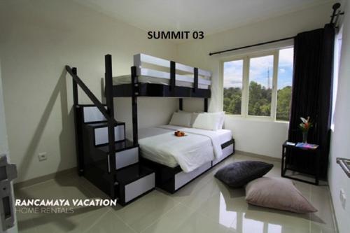 a bedroom with a bunk bed with a ladder at R Hotel Rancamaya in Bogor