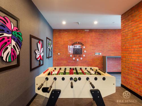 a room with a pool table in the middle of a room at Datum Jelatek Sky Residence KLCC, Five Senses in Kuala Lumpur