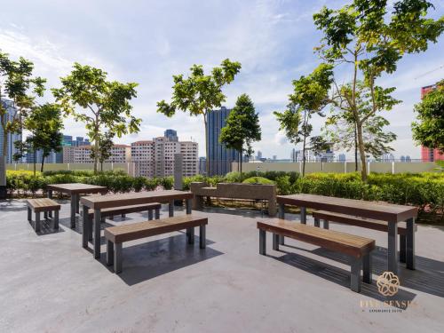 a group of picnic tables and benches in a park at Datum Jelatek Sky Residence KLCC, Five Senses in Kuala Lumpur