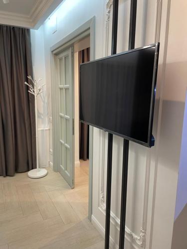 a flat screen tv on a stand in a room at Luxury City Studios in Curtea de Argeş