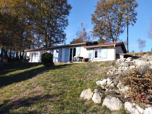 a white house on a hill with a yard at La Coste Blanque in Montaut