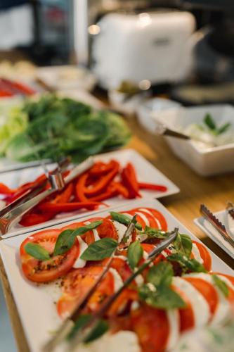 a plate of food on a table with vegetables at Villa Monica Apartamenty in Szczyrk