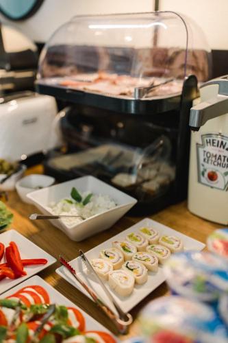 a table with sushi and other food on it at Villa Monica Apartamenty in Szczyrk