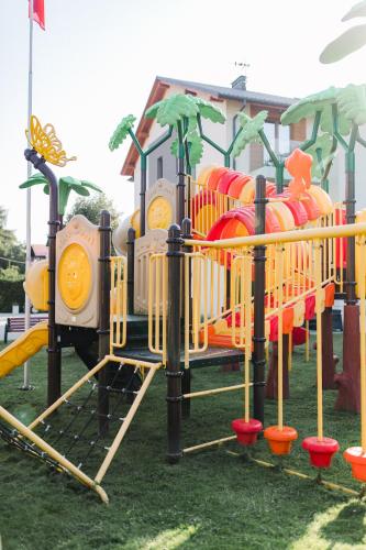 a childrens playground with a yellow and orange slide at Villa Monica Apartamenty in Szczyrk