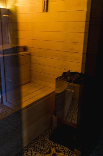 a wooden sauna with a trash can next to it at Villa Monica Apartamenty in Szczyrk