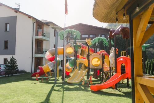 a playground with a slide in a yard at Villa Monica Apartamenty in Szczyrk