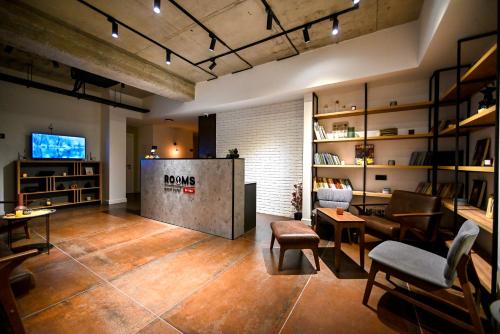 a room with a living room with a couch and a table at Rooms Apart Hotel by RED in Yerevan
