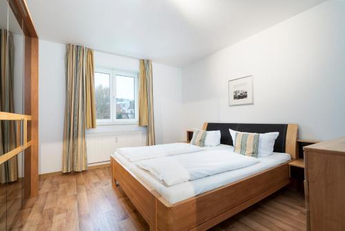 um quarto com uma cama e uma janela em Ferienwohnung Ostseeurlaub App 30 em Timmendorfer Strand