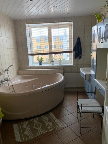 a bathroom with a tub and a sink at The Baltic coast apartment in Ventspils