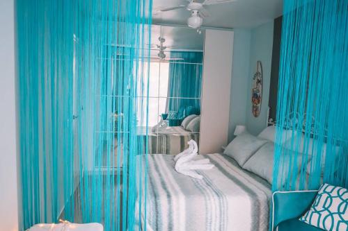 a bedroom with a bed with blue drapes at GREEN LAGOON in Calpe
