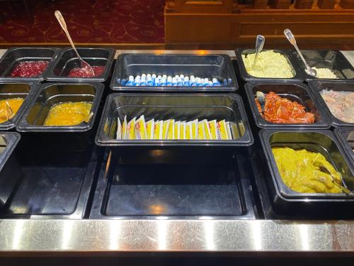 a buffet line with trays of different types of food at Park Hotel Vossevangen in Vossevangen