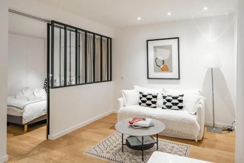 a living room with a couch and a table at Luxury Apartment 100 m to Palais des Festivals in Cannes