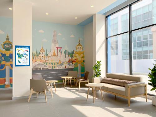 a waiting room with a mural on the wall at HOP INN Bangkok Krung Thonburi Station in Bangkok