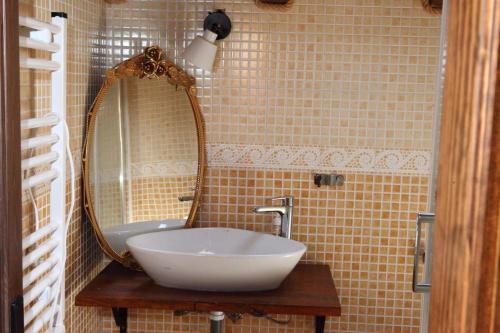 a bathroom with a white sink and a mirror at Mi capricho de Candeleda in Candeleda