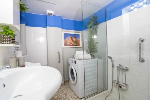 a bathroom with a washing machine and a shower at Marina's Bright Getaway - Nafplio Center House in Nafplio