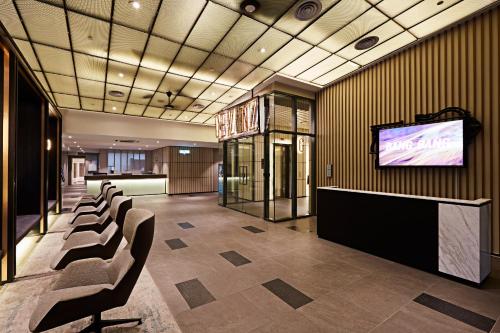 a conference room with chairs and a flat screen tv at Romantic Log Cabin - walk to KL Tower, KLCC, Bukit Bintang in Kuala Lumpur