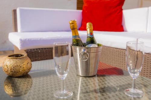 two bottles of champagne in a bucket on a table with glasses at Casa Bédar in Bédar