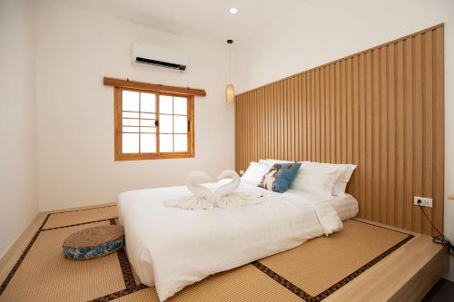 En eller flere senge i et værelse på Villa Sunrise Garden A180