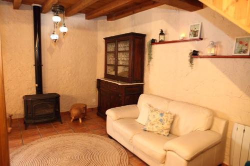 a living room with a couch and a wood stove at Mi capricho de Candeleda in Candeleda